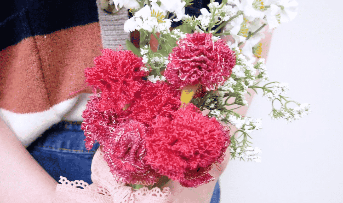 A person holding a bouquet of flowers

Description automatically generated with medium confidence