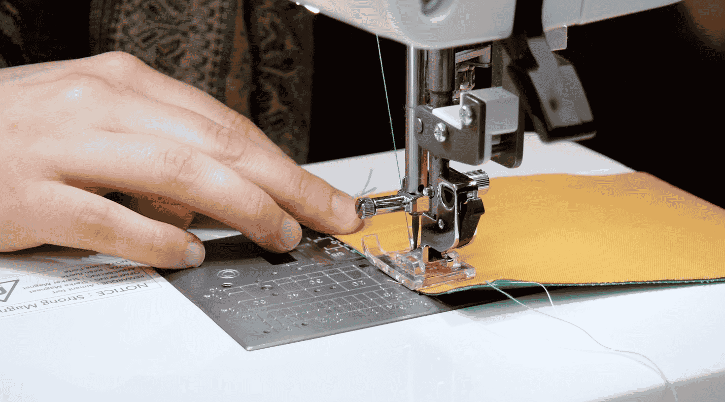 A picture containing text, sewing machine, indoor, person

Description automatically generated